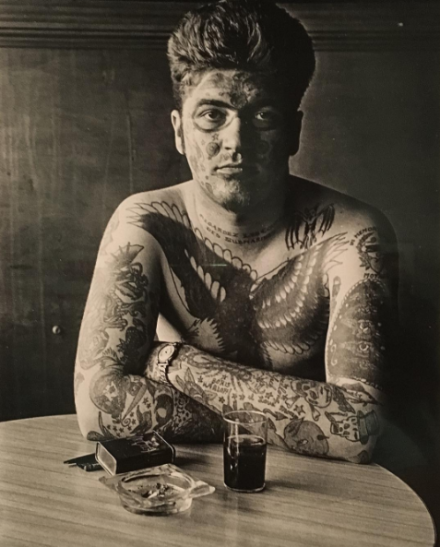 Diane Arbus, Jack Dracula at a bar, New London, Conn (1961), via Art Observed