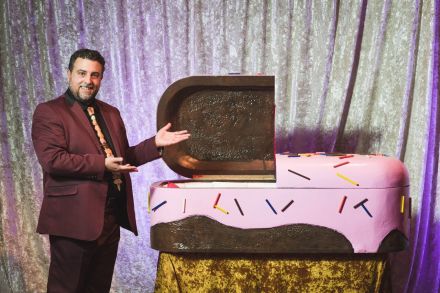 Actor Matthew Korahais presents a children's sugar coffin, courtesy Will Star Shooting Stars for Creative Time