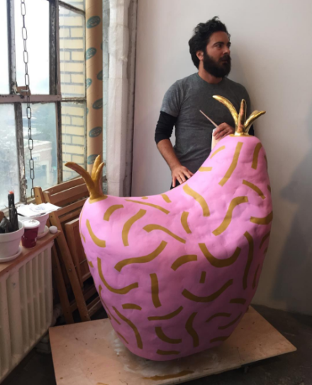 Artist Adam Frezza of duo CHIAOZZA with one of the duo's works, via Art Observed